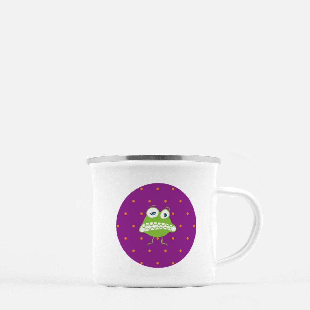 Greedy Goblin 10-oz. Camp Mug. Goofy green cartoon character  on a purple circle with orange polka dots on a white mug. 